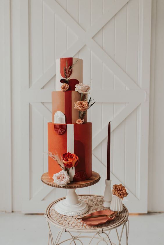 03-a-bold-orange-rust-blush-wedding-cake-with-bold-blooms-feathers-and-grasses-and-bright-sugar-detailing-for-a-70s-wedding